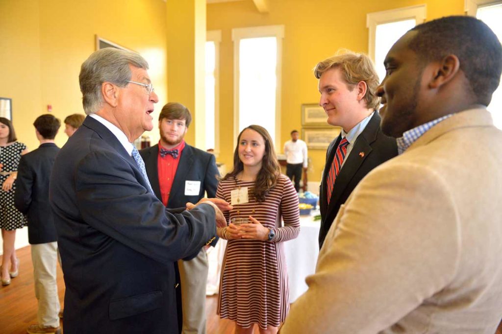 Trent Lott talks with students at a reception
